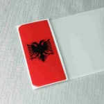 Albania flag number plate badge with double-headed eagle emblem.