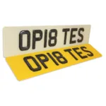 Glitter 3D number plates with raised characters on white and yellow plates.